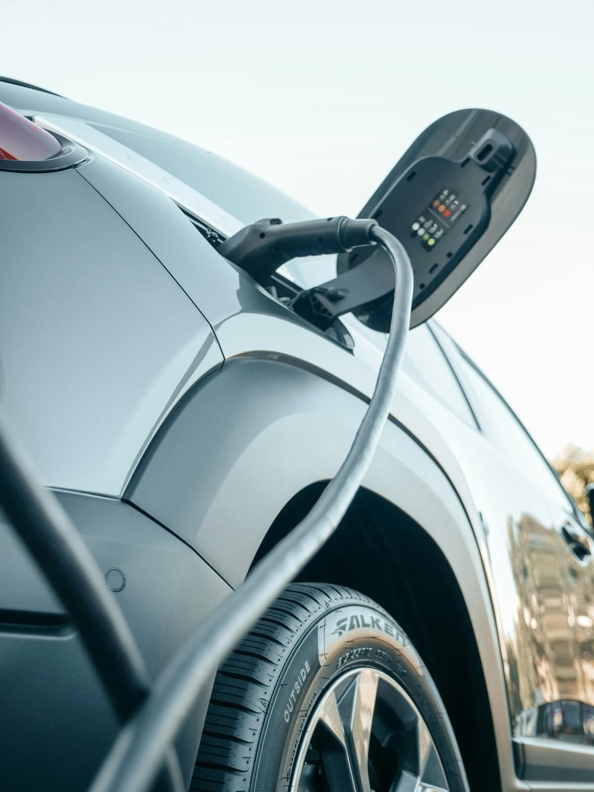 Electric vehicle plugged in and charging at home