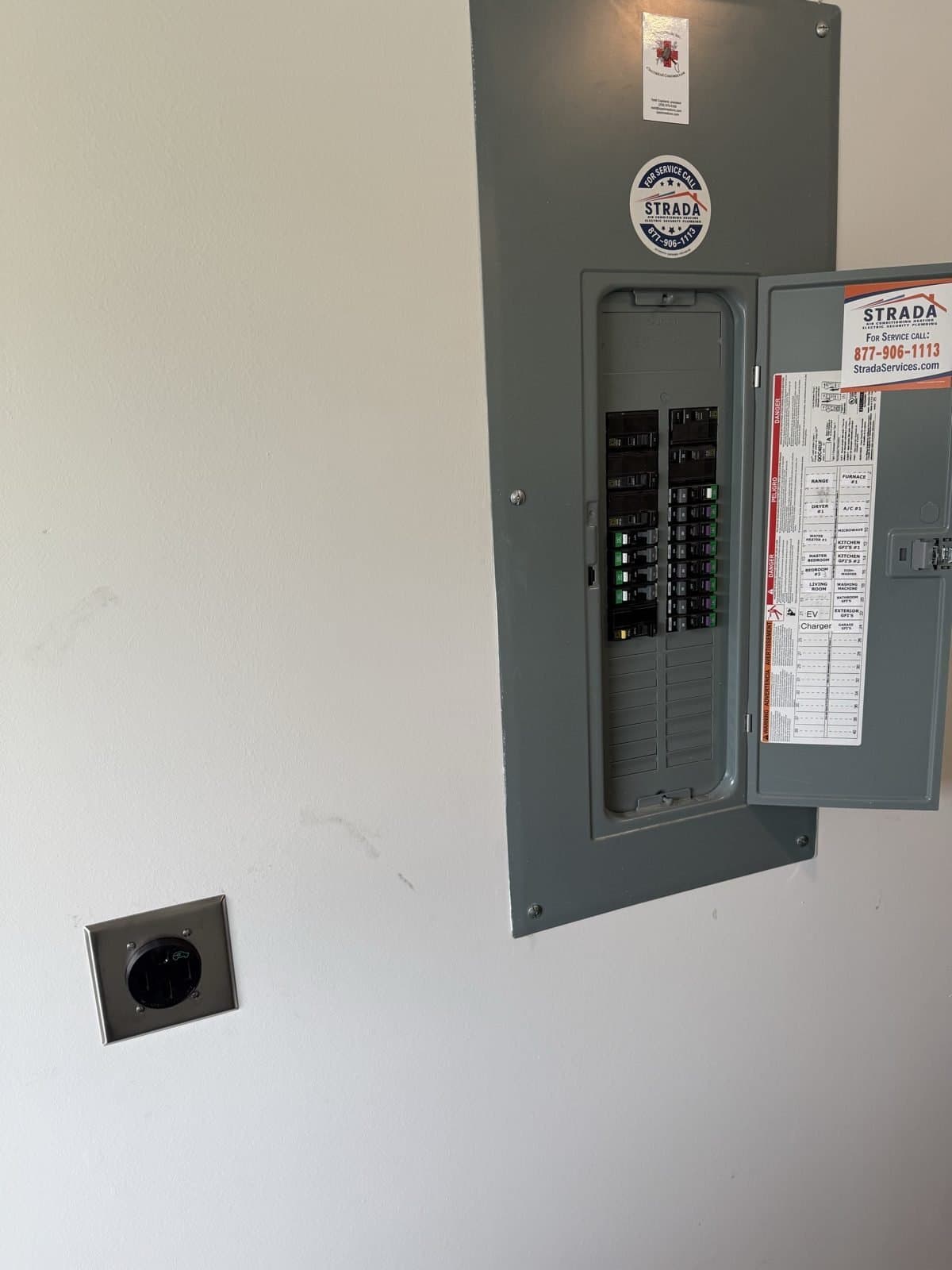 GFCI-protected continuous-duty 14-50 EV receptacle installed by Spark Medic next to the electrical panel