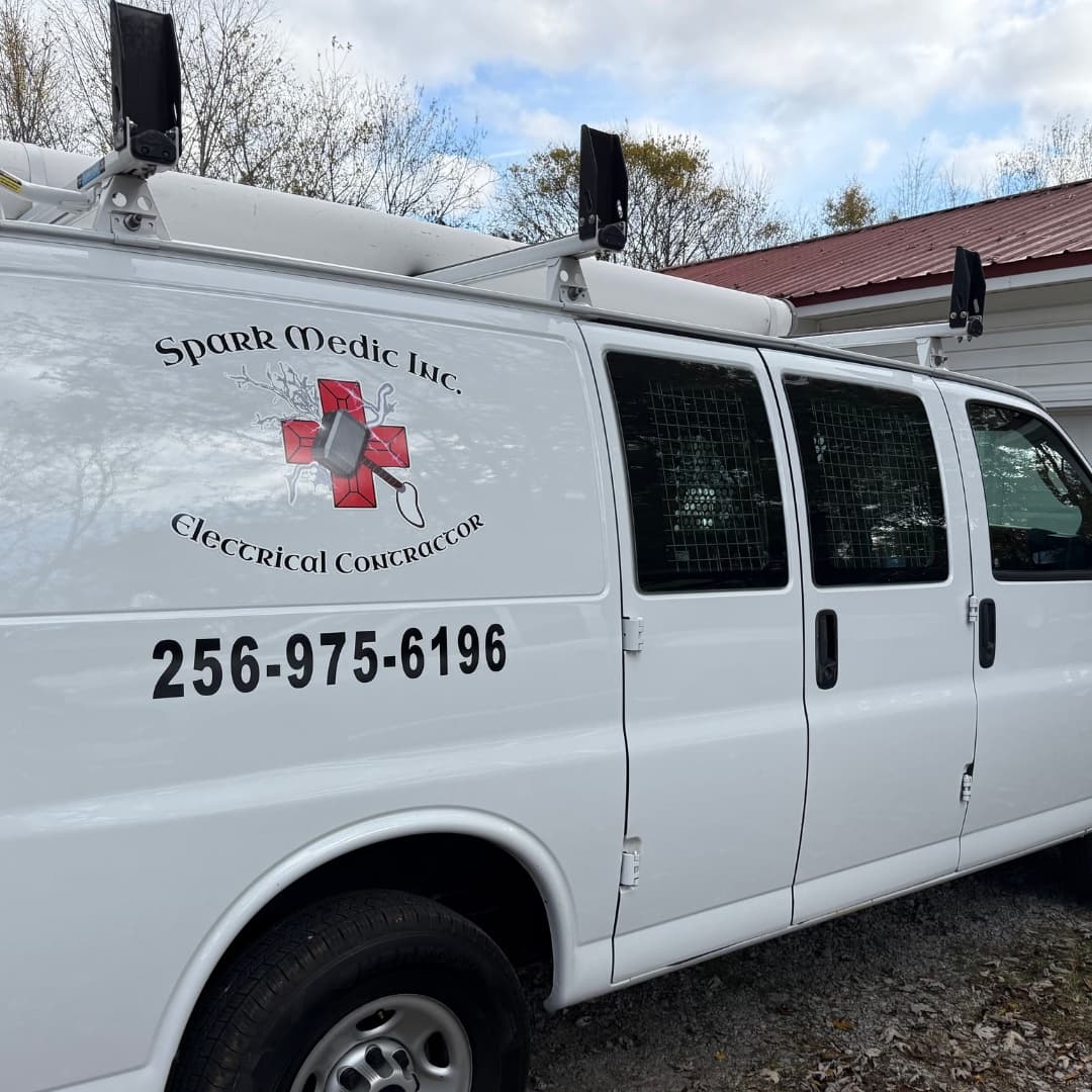 Spark Medic Inc branded work van with logo and phone number