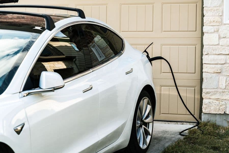 Tesla charging with a Level 2 home EV charger installed at a Huntsville garage